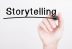 Storytelling - Imagem com fundo branco e uma pessoa escrevendo a palavra "Storytelling".